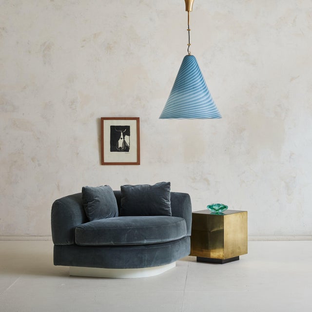 Sold and priced individually. A 1970s Italian corner chair attributed to Marzio Cecchi. Upholstered in plush, slate-blue...