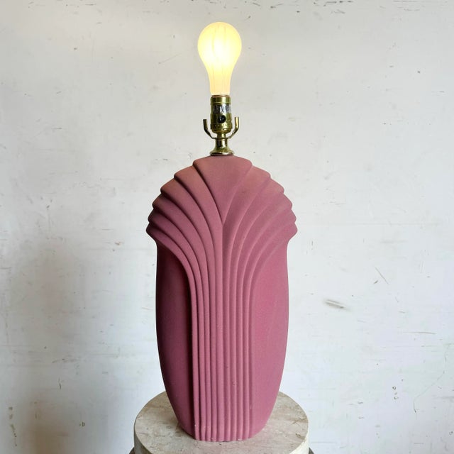 Bring bold, postmodern flair to your decor with this hot pink scalloped table lamp. Its rough-textured surface and dynamic...