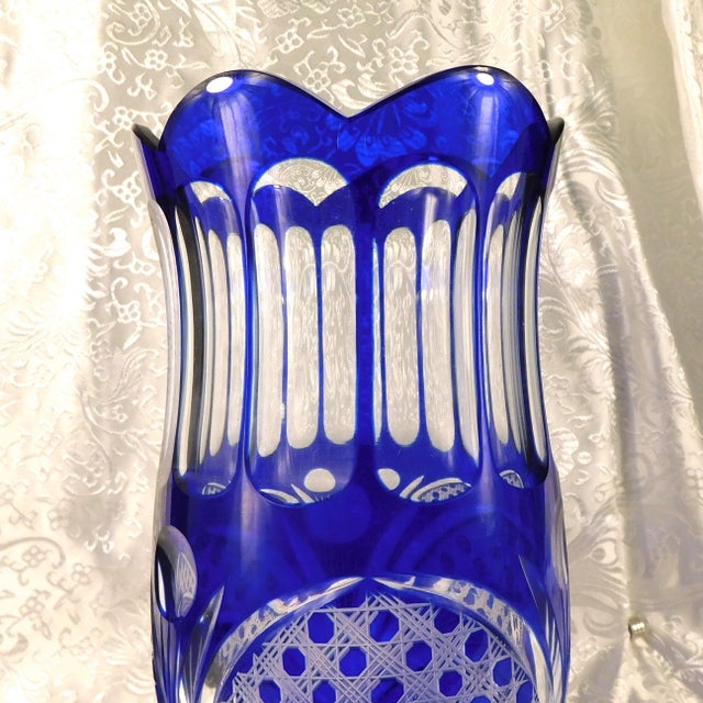 This is a blue cut to clear vase. I have two of them, but they are not exactly the same. This one has a more scalloped...