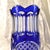 This is a blue cut to clear vase. I have two of them, but they are not exactly the same. This one has a more scalloped...