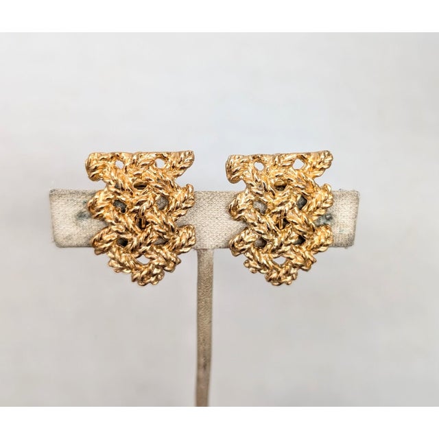 1960s goldtone lattice elongated pentagon shape clip and screw back earrings. Marked "Napier." Measure: 1 3/16 inches long...
