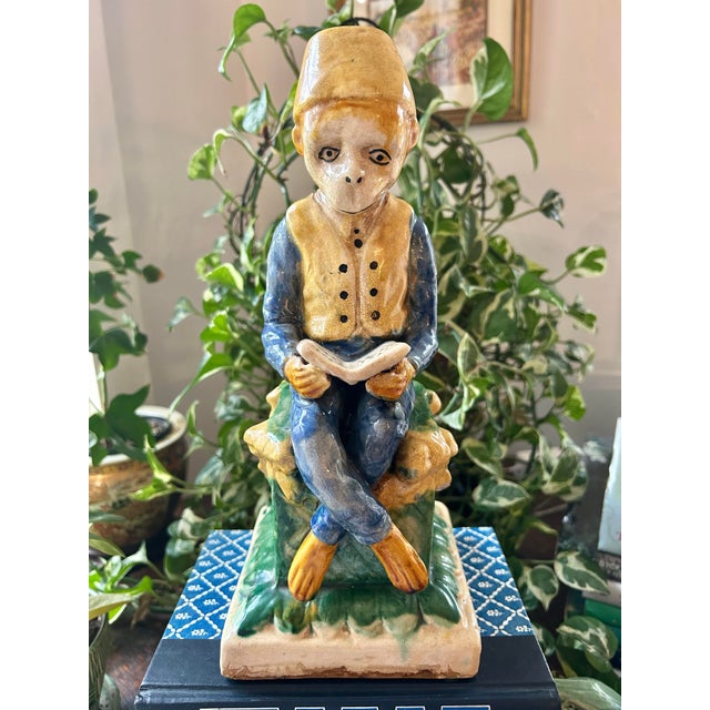 Likely made between 1940 and 1960, this pensive monkey is majolica style pottery and could be used as a bookend or on a...