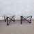 Rare pair of round coffee tables with glass tops, resting on sculpted varnished wood bases. The base of each table is...