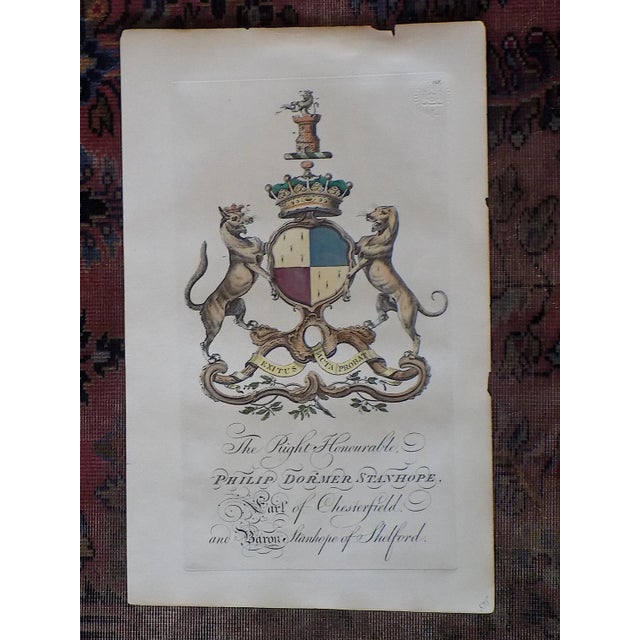 This rare antique 18th century hand colored copperplate engraving depicts the heraldric crest of Sir Philip Dormer...