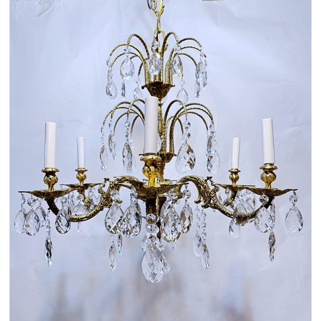 This is a Spanish style bronze chandelier with ornate designed frame and dressed with Swedish style hand cut crystal. It...
