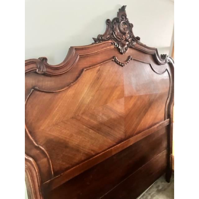 A magnificent complete 19th-century French Rococo Revival walnut bedstead, originally imported from France. Purchased...