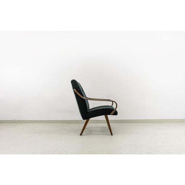 A pair of vintage armchairs designed by Jaroslav Smídek in the 1960s for Ton, Czechoslovakia. The armchairs are made of...