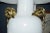 Statement-scale white ceramic urn lamp with dramatic sculptural gilt-brass handles that curl at the shoulders and drop...