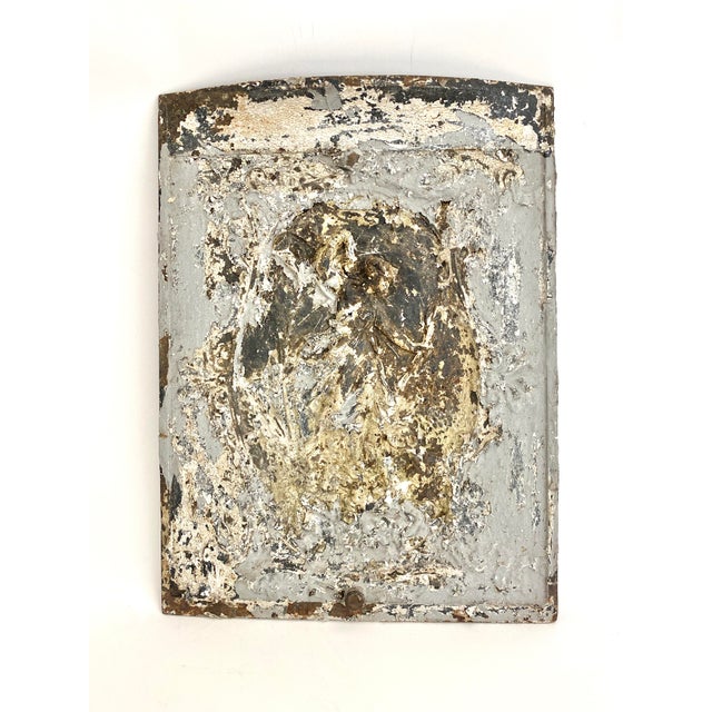 Sourced in New Orleans, this cast iron high relief summer fireplace screen has layers of paint that have left it with...