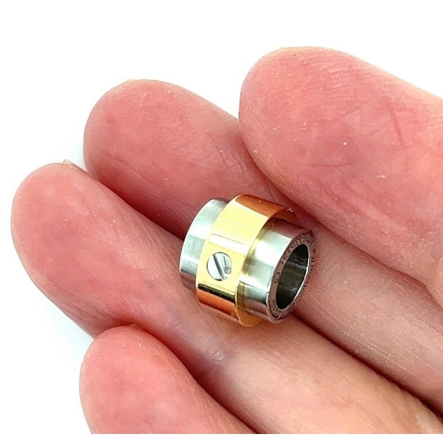 Elevate your jewelry collection with the Cartier Santos 18k Gold & Stainless Steel Barrel Slide Charm Pendant. A testament...