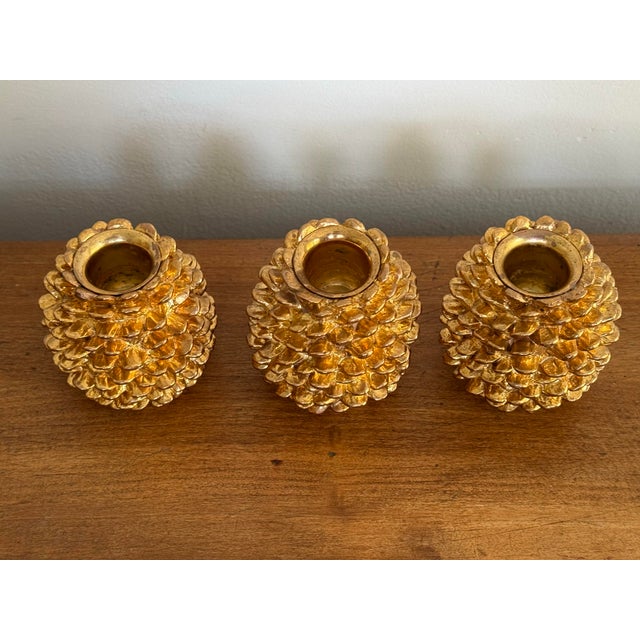 Pretty trio of gold pinecone candlestick holders, made by Department 56. Perfect winter shine. Please see condition...