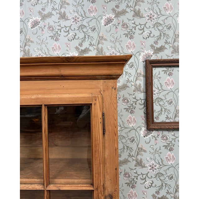 This solid pine display cabinet captivates with its elegant simplicity and authentic charm. Inspired by country furniture,...