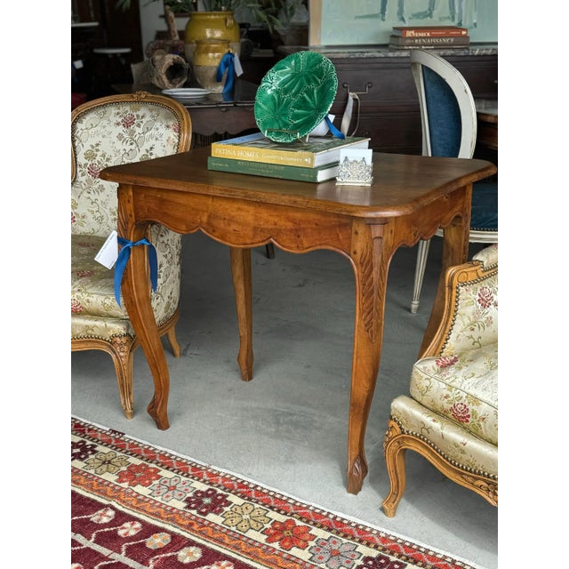 This Louis XV walnut side table, characterized by its elegant and graceful design, features rich walnut, known for its...