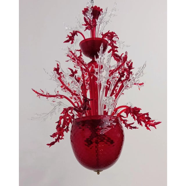 Hand -worked Murano glass chandelier. Red and transparent color. Model called "Corallo" by the master window of Murano who...