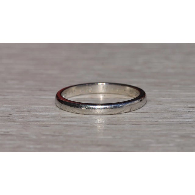 The Preston: Antique Platinum Wedding Band. The simple modified cigar style band is crafted in platinum and features the...
