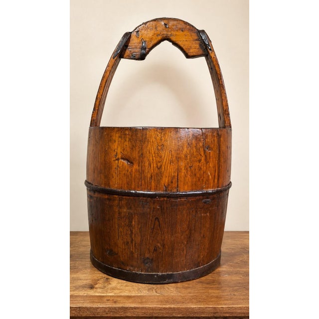 Traditional Chinese water bucket (水桶, shuitong) dating from the late Qing dynasty, 19th century. Constructed from wooden...