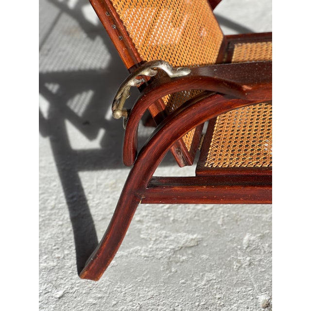 Adjustable Morris armchair no. 6392 by Otto Prutscher for Thonet, Austria, 1905, in mahogany. Cane back and seat. Brass...
