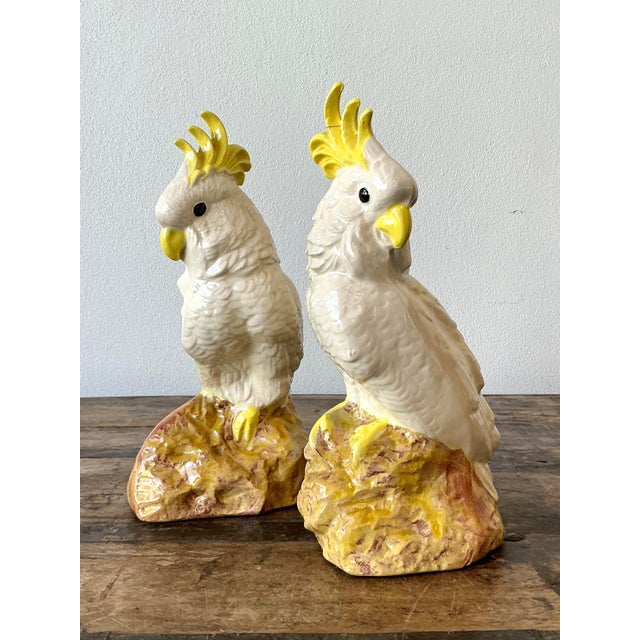 Elevate your interior with this striking pair of vintage glazed ceramic cockatoo statues, a quintessential example of...