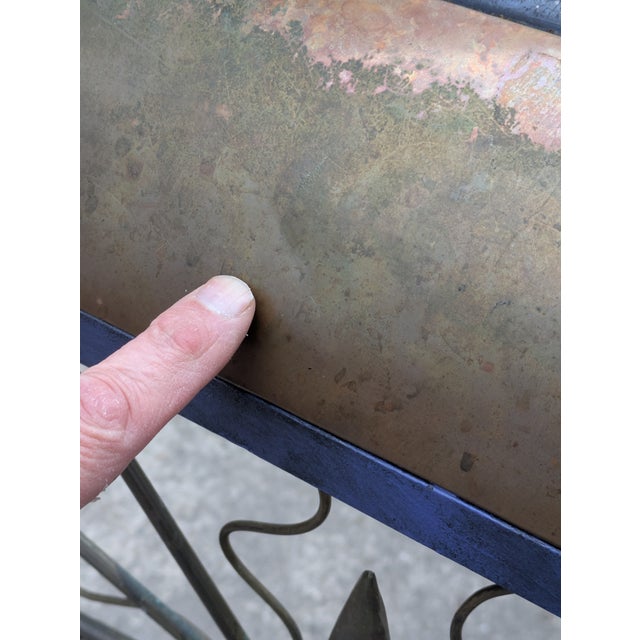 This rare and wonderful chair is constructed of iron and accented with brass and copper. The iron fram has a modeled...