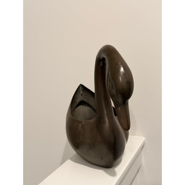This sculptural bronze swan planter showcases elegant, minimalist lines and a timeless animal form characteristic of...