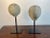Pair of spheres mounted on iron bases. One is 19th century and is made of stone. The second sphere is made of cement and...