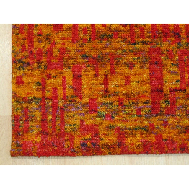 A hand-knotted silk rug, made in India and measuring 8' x 10'. Loose, abstract drawing rather than a formal repeating...
