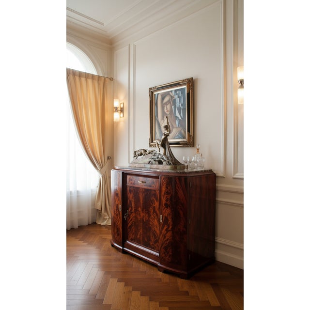 Museum-Quality French Art Deco Flame Mahogany Sideboard with Limousin Bronze Hunt Sculpture A breathtaking example of...