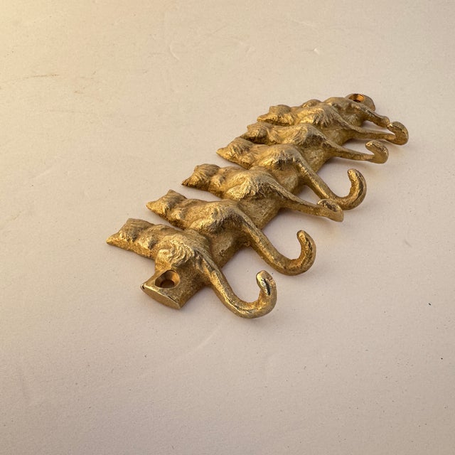 Whimsical key hooks of a seven perched kitties, with six of their tales doubling as a hook for your keys or lanyard. Such...