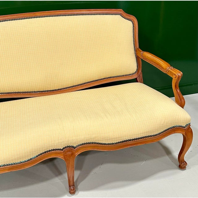 Designed by John Hutton for Sutherland, this finely crafted 61-inch teak settee combines the elegance of classic French...