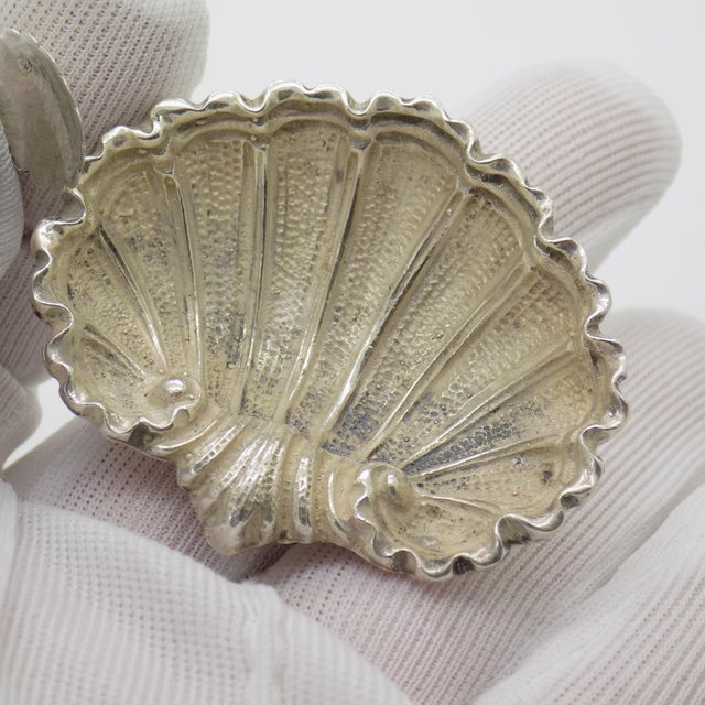 Vintage salt or pepper cellar shaped like a shell, made in genuine 800 silver, complete with a small spoon, dating to the...