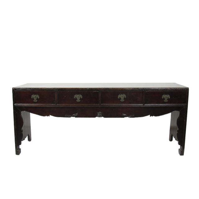 This antique Chinese table has 4 drawers adorned by the hand made bat brassware and hand carved rolling rims along inner...