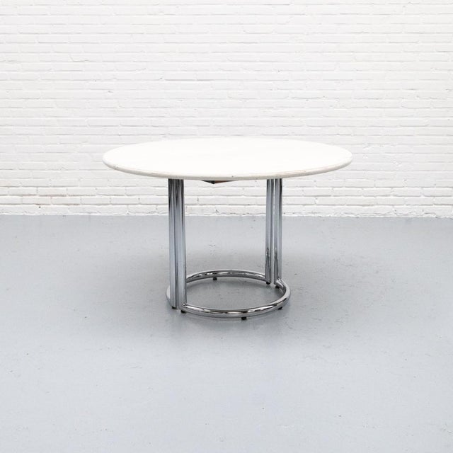 1970s extendable dining table, produced by Läsko in Germany. It features an elegant chrome base and a white-stained ash...