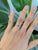 A natural color-change alexandrite sits at the center of this solid 14K white gold ring, flanked by four earth-mined...
