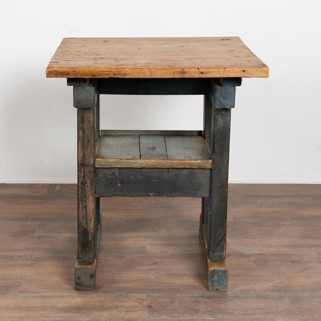 19th-century rustic pine side table or console featuring a painted base and center shelf. The base displays layered shades...