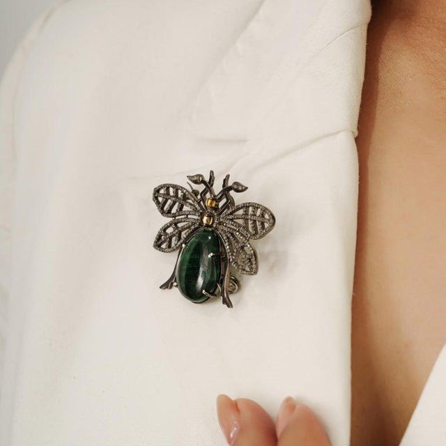 This whimsical 15.35 carat emerald, citrine, and diamond beetle brooch pendant is crafted in 925 sterling silver....