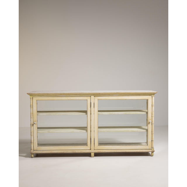 A decorative vitrine featuring faux bamboo detailing, reflecting the European fascination with Asian-inspired design...