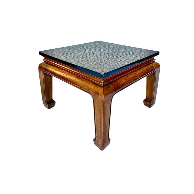 This sophisticated pair of mid-century low tables in aged mahogany features a classic Ming leg and wonderful stone tops...