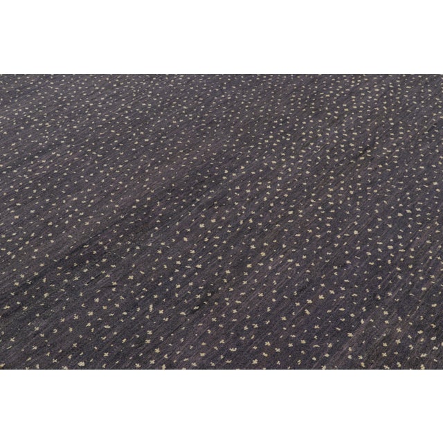 Hand-knotted in wool and silk, this 9x12 contemporary rug from Rug & Kilim features geometric patterns with a modern...