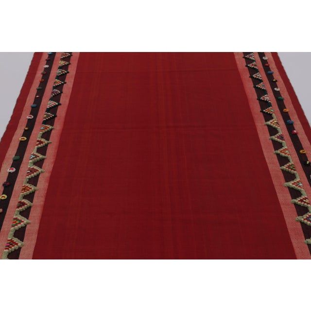 Made with handwoven wool circa 1950-1960, this 5x7 vintage flat-weave Kilim is a particularly intimate and sought-after...