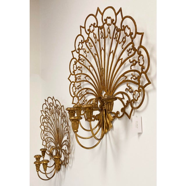 Impressively large scale gilt fan wall candelabra sconces. Each sconce features a single wood arm with five taper candle...