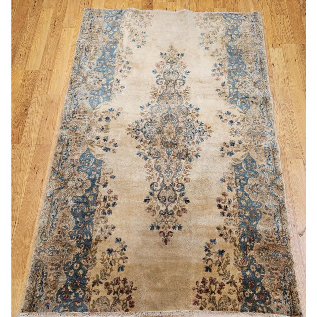 "This vintage Persian Kerman rug, hand-knotted in the second quarter of the 20th century, showcases the refined elegance...
