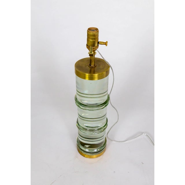 A lamp with a timeless, modern design fitting many styles. Most notable about the piece is the optical magnifying effect...