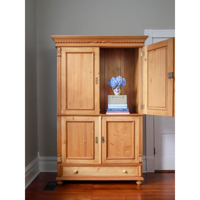 Looking for the perfect place to conceal your TV? Look no further. This early to mid 20th century English pine linen press...