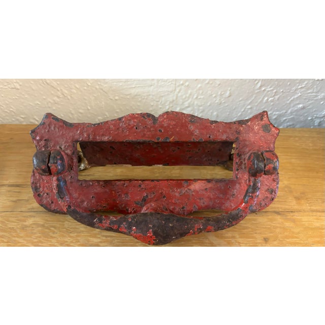 A very good 19th door knocker with letter slot. Beautifully worn red paint. Hand selected in and imported from England....