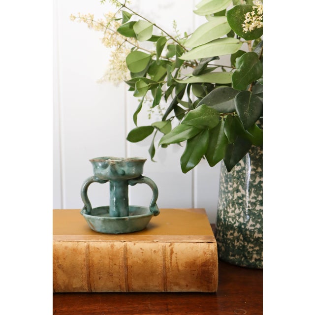 Mid-century handmade Italian handled candle with a gorgeous green glaze. MEASURES 4”W x 4”H
