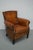 This cognac-colored leather club chair comes from the Netherlands. It is upholstered with cognac-colored leather and...