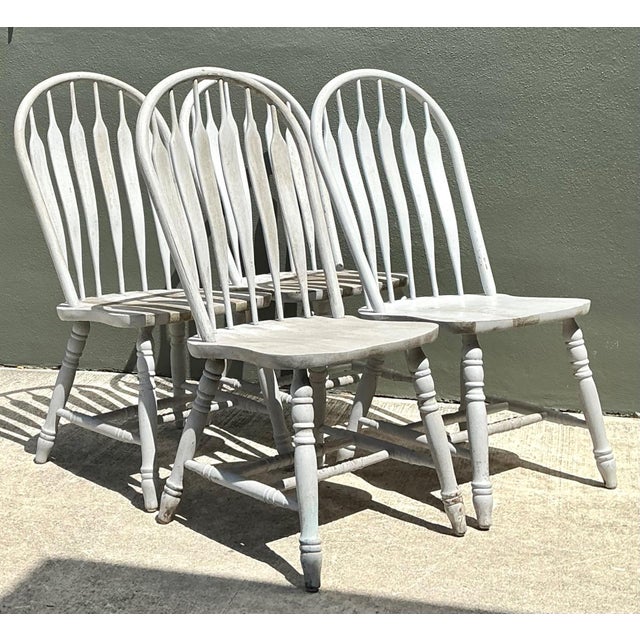 Bring timeless farmhouse charm to your interior with this set of four vintage Windsor dining chairs, beautifully crafted...