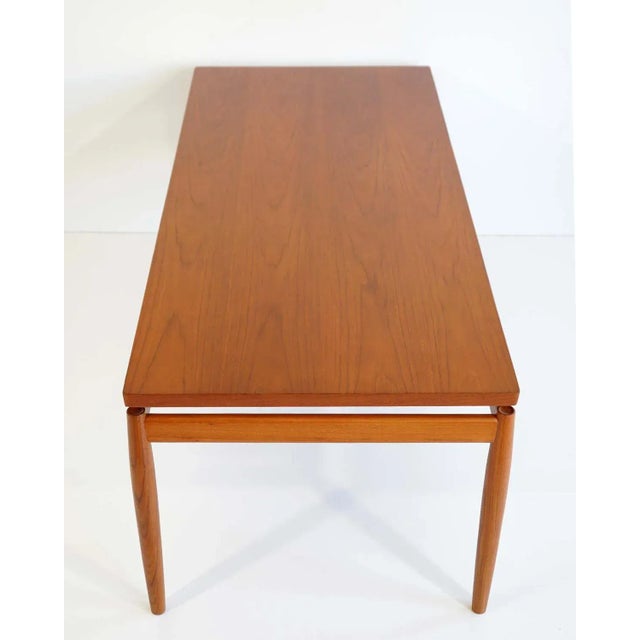 Restored Mid-Century Modern coffee table designed by Grete Jalk and made in Teak by France & Son, Denmark 1960s. The main...