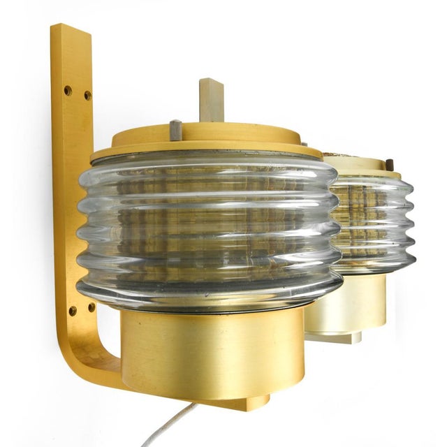 A pair of 1960's Swedish brass and fluted glass wall sconces. The glass diffusers function as light shades. Hans-Agne...