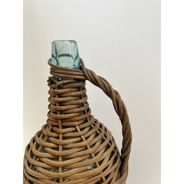 Tall glass bottle wrapped in wicker.